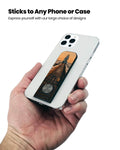 Showing the Flickstick on the back of a phone being held by a hand.