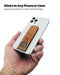 Showing the Flickstick on the back of a phone being held by a hand.